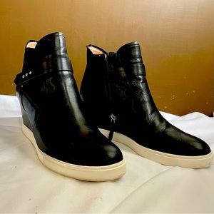 Wedge high top sneaker. Side zip, elastic side insets, adjustable strap.